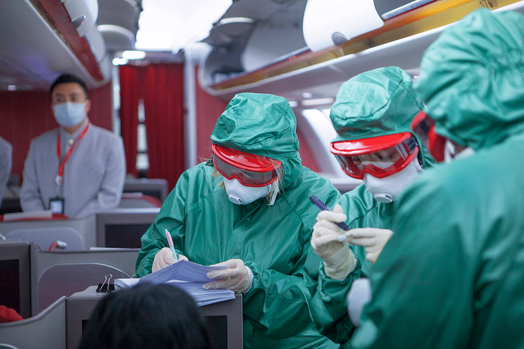 Doctors screening for coronavirus on an airplane