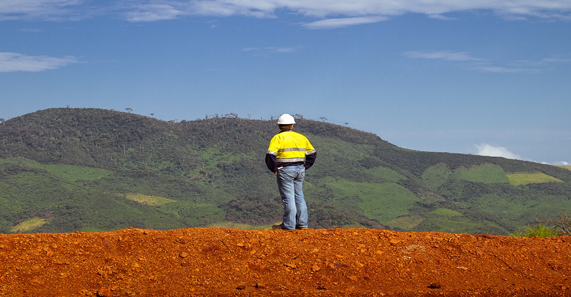 mining construction worker standing on a hill